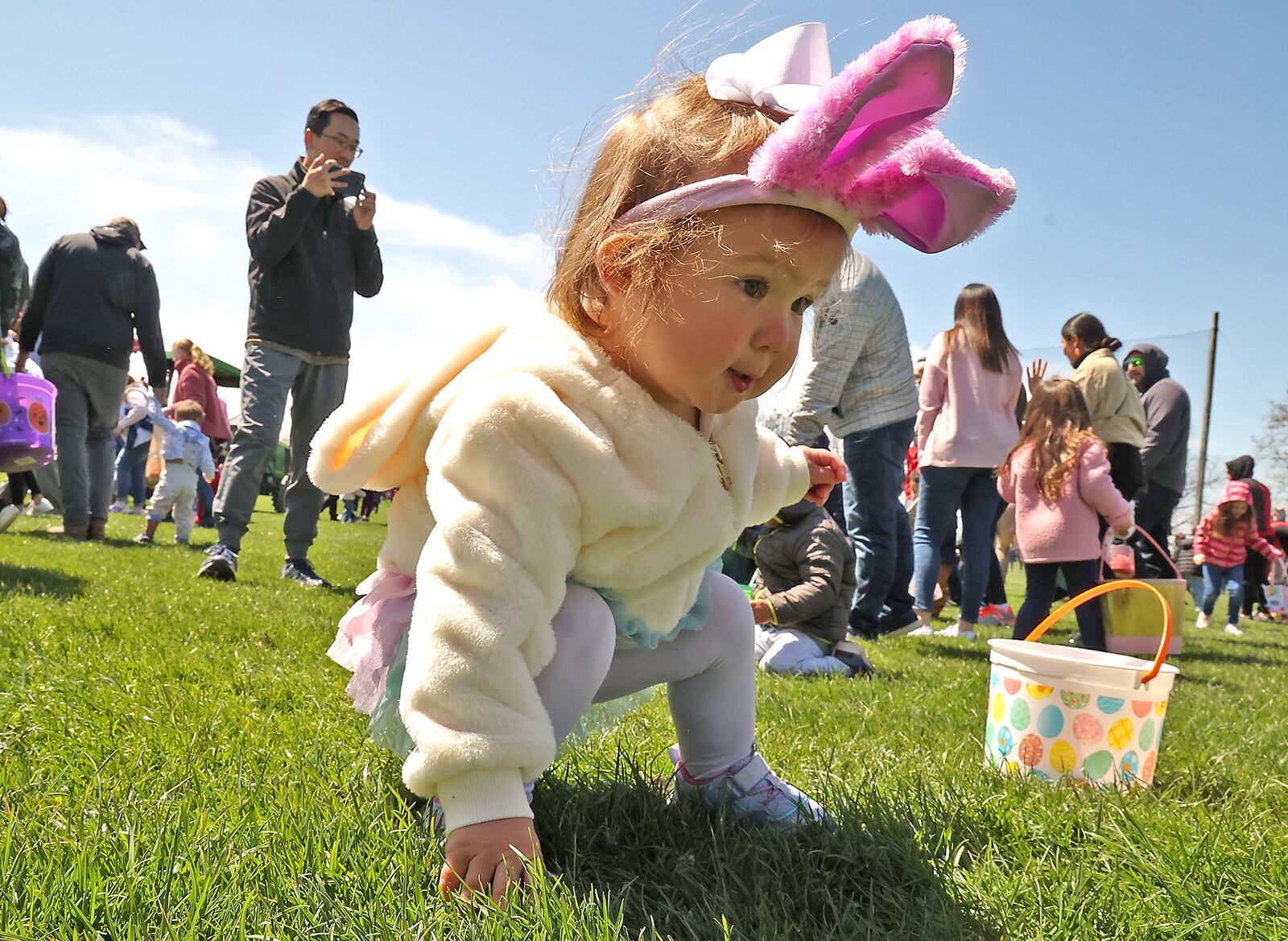 One-year-old Arielle Martin wears her bunny ears as she joined hundreds of other children in the Easter egg hunt at Young's Jersey Dairy Sunday. This was the 39th anniversary for the egg hunt, however, the hunt wasn't held for the past two years due to the COVID pandemic. This year Young's put out over 10,000 dyed eggs for the children to collect. BILL LACKEY/STAFF