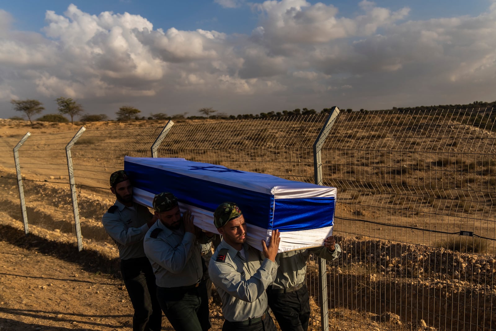 Israeli soldiers carry the coffin of captain Yogev Pazi, who was killed in Gaza, during his funeral at the cemetery of Giv'ot Bar, southern Israel, Monday, Nov. 18, 2024. (AP Photo/Francisco Seco)