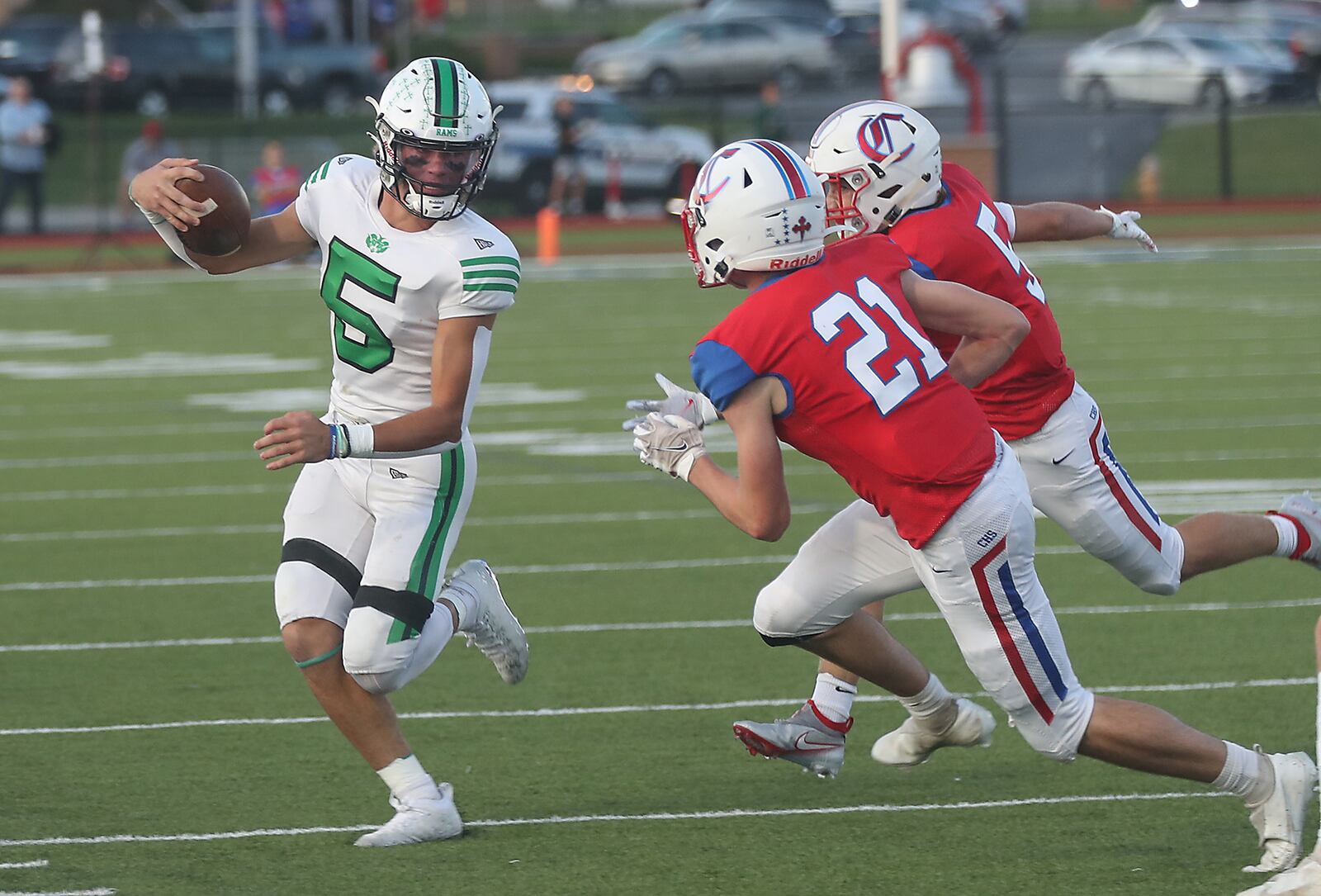 Badin's Landyn Vidourek tries to avoid a tackle by Carroll's Jack McGeady and Tristan Heasley. BILL LACKEY/STAFF