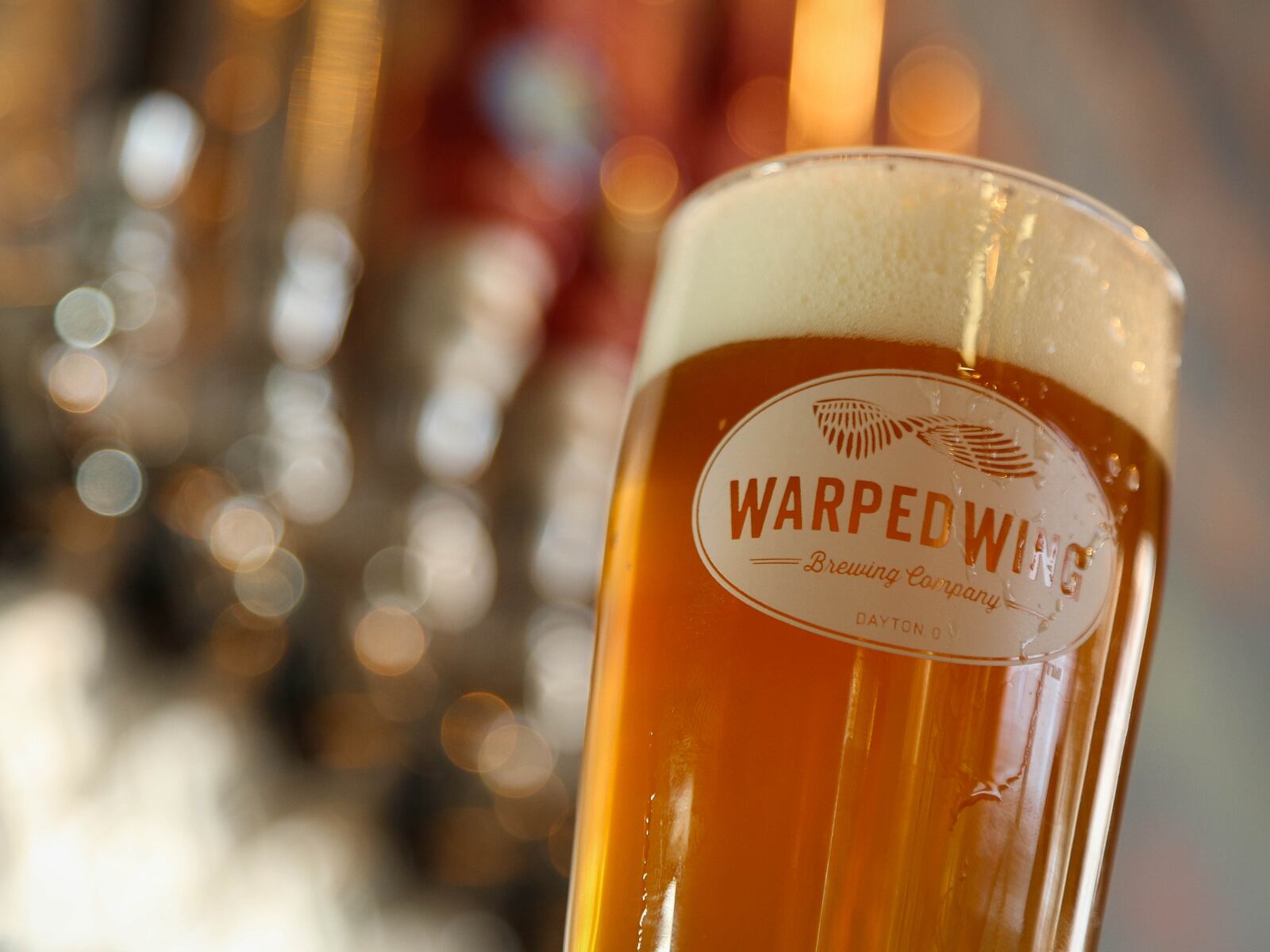 "Hop Smuggler" on the bar of the tasting room at Warped Wing Brewing Company production facility at  26 Wyandot Street, Dayton. JIM WITMER / STAFF