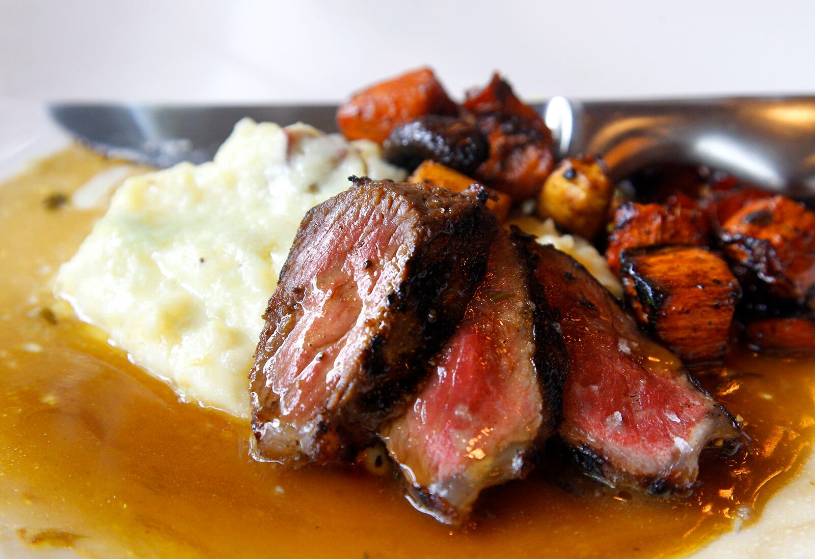 Cooperâs Hawk Winery & Restaurant, located in the Cornerstone of Centerville, opens Monday, Aug. 26. Ginger soy glazed center-cut NY strip with wasabi-buttered mashed potatos and oven-roasted vegetables is among the entrees. LISA POWELL / STAFF