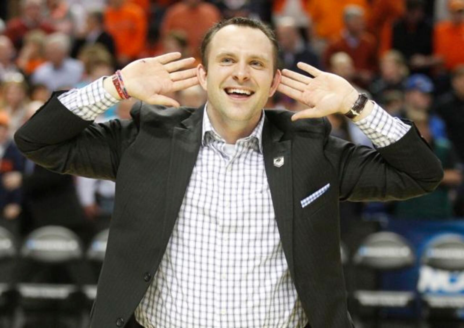 Eric Farrell, Dayton's assistant director of basketball operations, celebrates after a victory against Ohio State in the second round of the NCAA tournament on Thursday, March 20, 2014, at the First Niagara Center in Buffalo, N.Y.