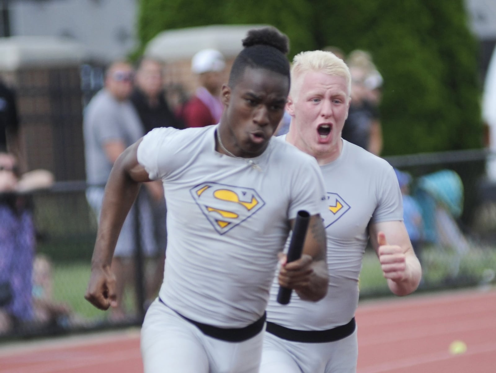 Springfield’s Jacob Yost (right) hands off to Quincy Scott in th runner-up D-I 4x100 relay during the state track and field meet at OSU’s Jesse Owens Memorial Stadium in Columbus on Saturday, June 2, 2018. MARC PENDLETON / STAFF