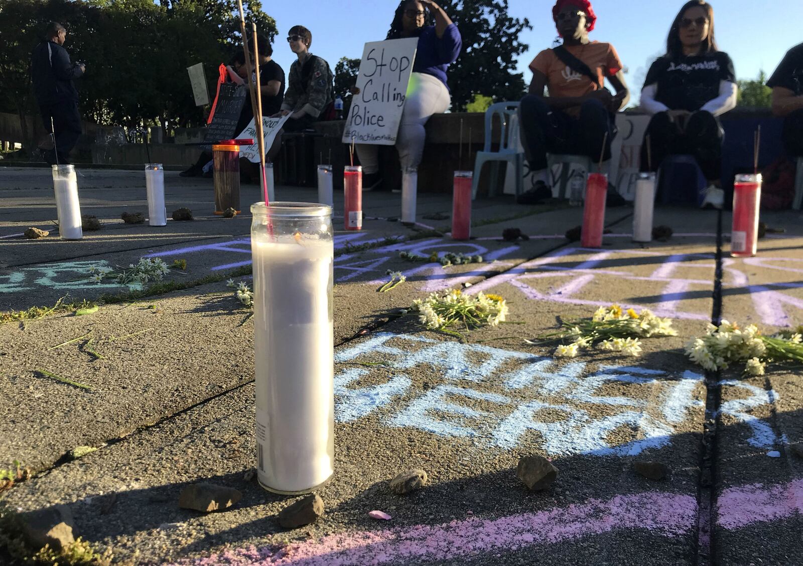 People gather for a memorial during a protest in Charlotte, N.C., Monday, April 15, 2019. The protesters were reacting to the release of police body camera footage showing a Charlotte-Mecklenburg police officer shooting 27-year-old Danquirs Napoleon Franklin outside a Burger King on March 25. Franklin appeared to be dropping a handgun, per officers' commands, when he was shot.