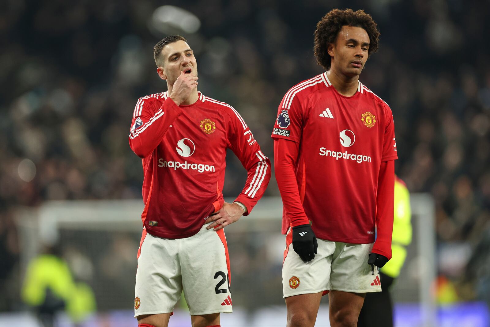 Manchester United's Diogo Dalot, left, and Joshua Zirkzee react after the English Premier League soccer match between Tottenham Hotspur and Manchester United in London, Sunday, Feb. 16, 2025. (AP Photo/Ian Walton)