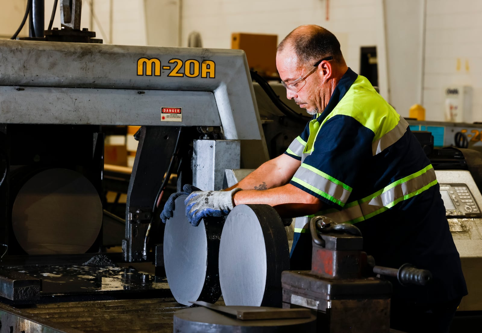 Phil Davis cuts steel cylinders to customer specifications at Industrial Tube & Steel Tuesday, Aug. 16, 2022 in West Chester Township. This company, like many others, is dealing with inflation, supply chain and staffing issues. NICK GRAHAM/STAFF