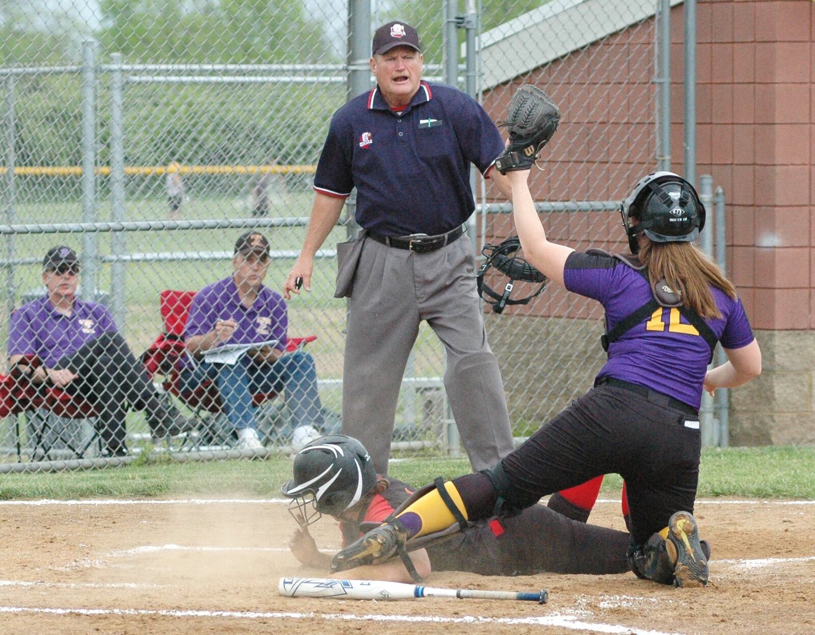 Fenwick’s Claudia Miller is about to be called out at home plate after a tag by Bellbrook catcher Sami Seubert (12) on Thursday during a Division II sectional softball game in Middletown. Bellbrook won 9-5. RICK CASSANO/STAFF