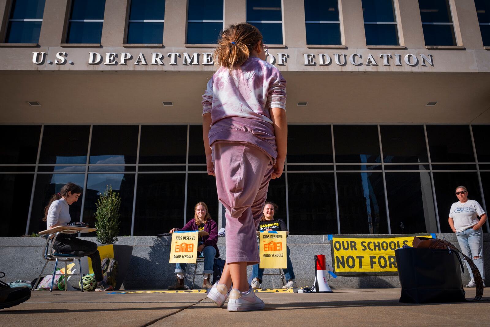 Alejandra Rodriguez, 9, of Key Largo, Fla., watches as college students protest in support of the Department of Education, Thursday, March 20, 2025, outside the department in Washington. (AP Photo/Jacquelyn Martin)