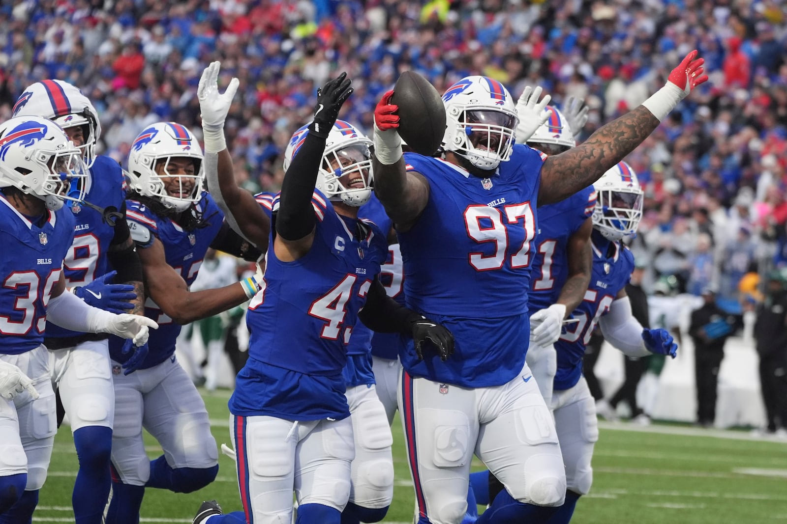 Buffalo Bills defensive tackle Jordan Phillips (97) celebrates after making an interception against the New York Jets during the first half of an NFL football game, Sunday, Dec. 29, 2024, in Orchard Park, N.Y. (AP Photo/Gene J. Puskar)