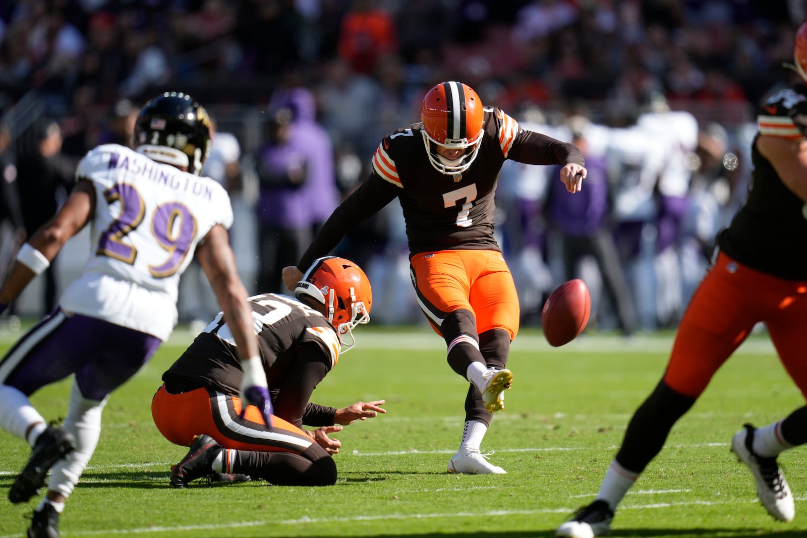 Cleveland Browns place kicker Dustin Hopkins (7) kicks a field goal from the hold of Corey Bojorquez (13) against the Baltimore Ravens during the first half of an NFL football game in Cleveland, Sunday, Oct. 27, 2024. (AP Photo/Sue Ogrocki)