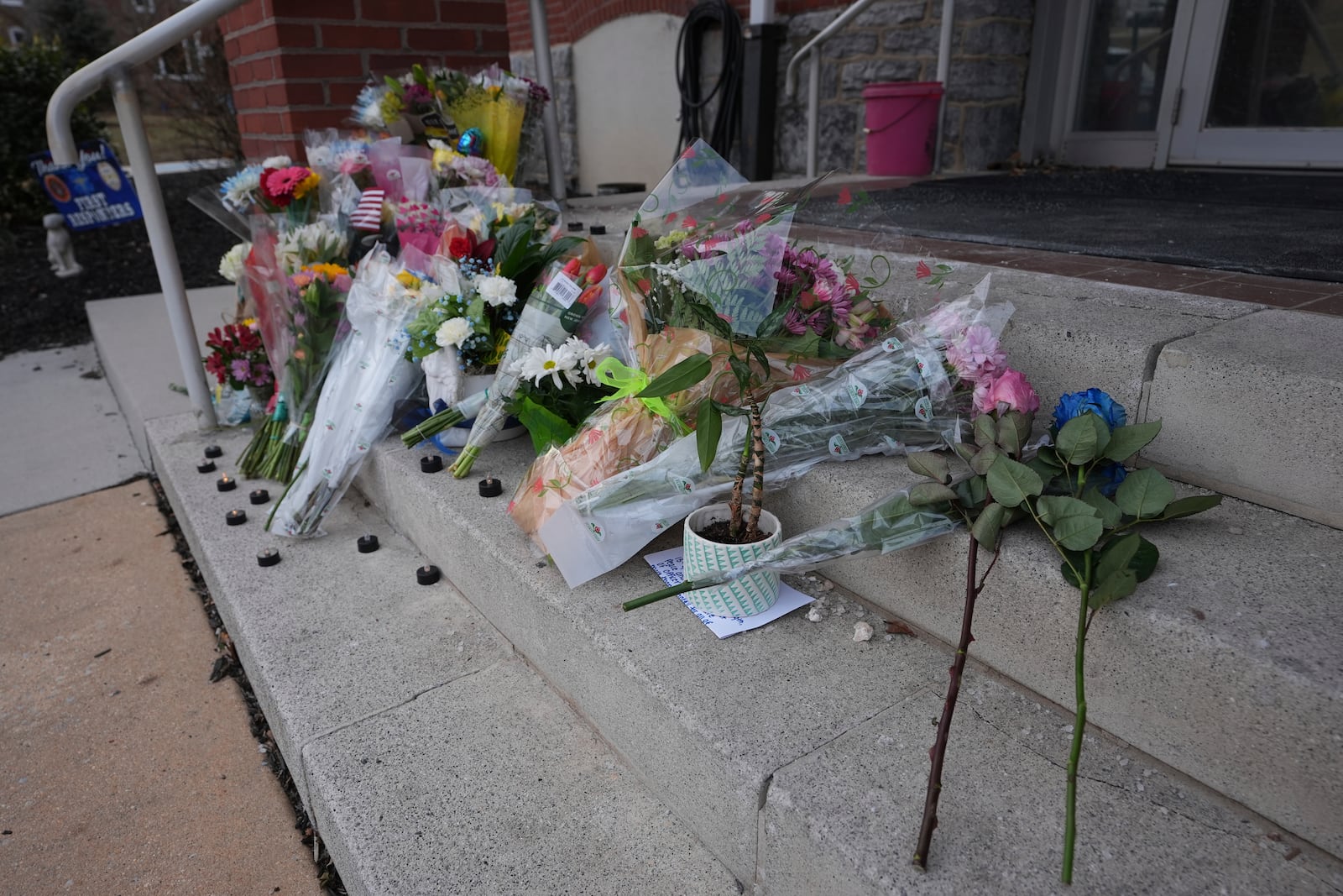 Flowers are placed in front of the West York Police Department after a police officer was killed responding to a shooting at UPMC Memorial Hospital in York, Pa. on Saturday, Feb. 22, 2025. (AP Photo/Matt Rourke)