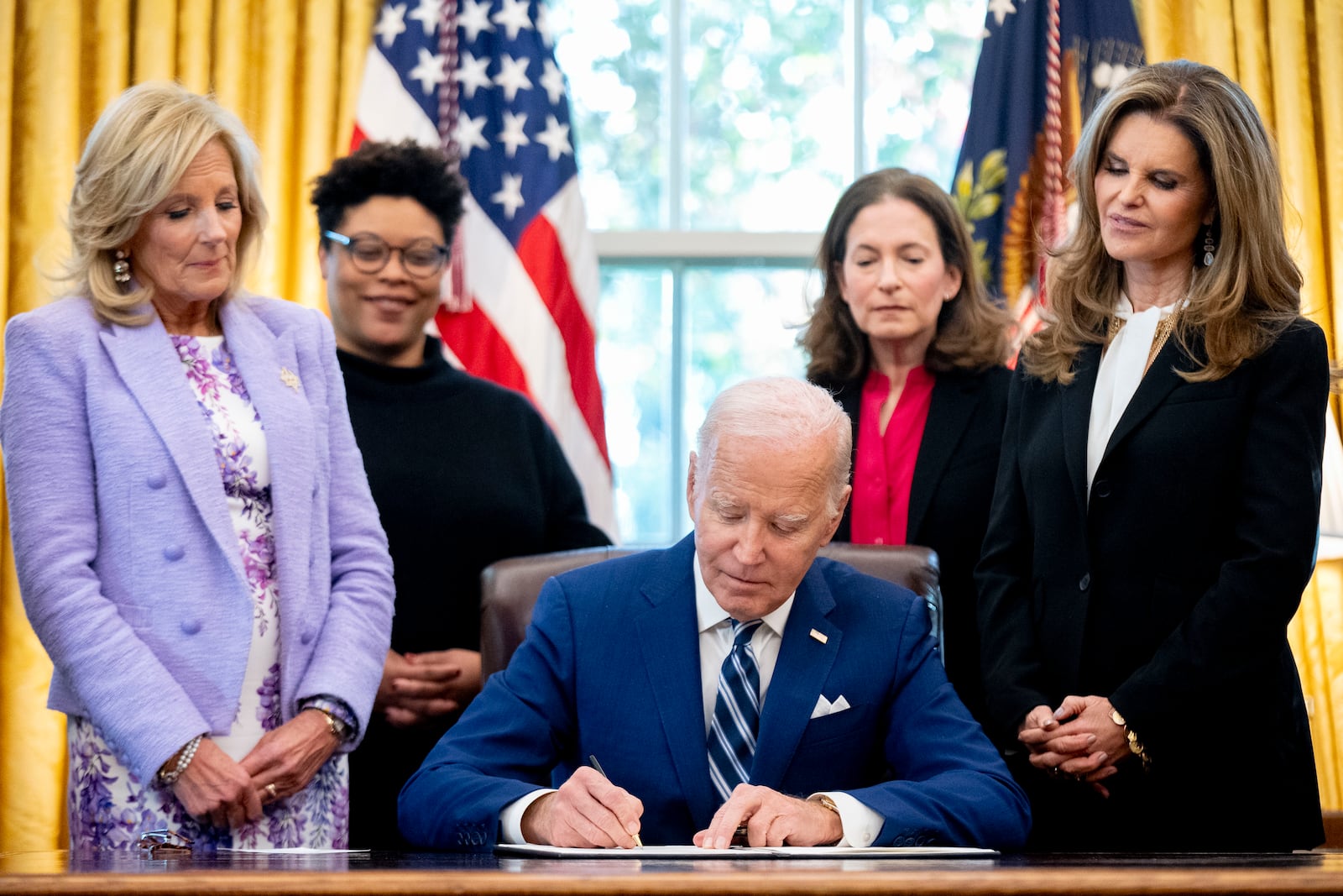 President Joe Biden,signs a presidential memorandum that will establish the first-ever White House Initiative on Women's Health Research in the Oval Office of the White House, Monday, Nov. 13, 2023, in Washington. (AP Photo/Andrew Harnik)