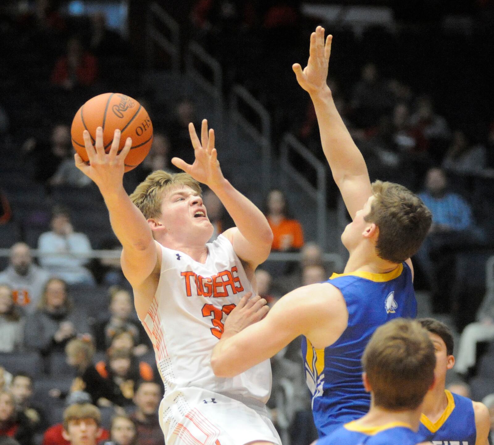 Versailles senior A.J. Ahrens (shooting) is confronted by by Madeira defender. MARC PENDLETON / STAFF