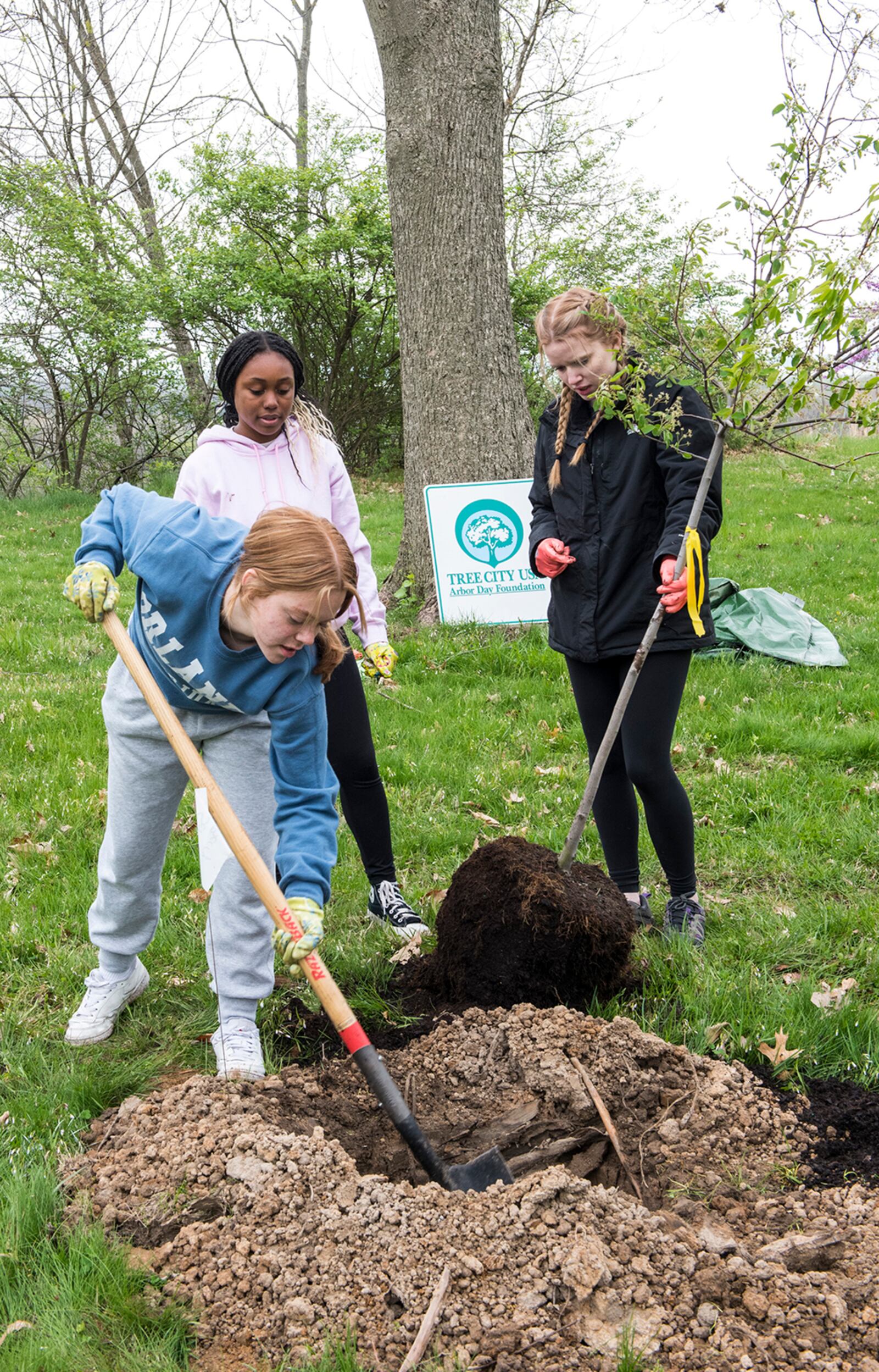 Students from the Fairborn High School Environmental Club plant trees during an Arbor Day event on April 26 at Wright-Patterson Air Force Base. U.S. AIR FORCE PHOTO/JAIMA FOGG