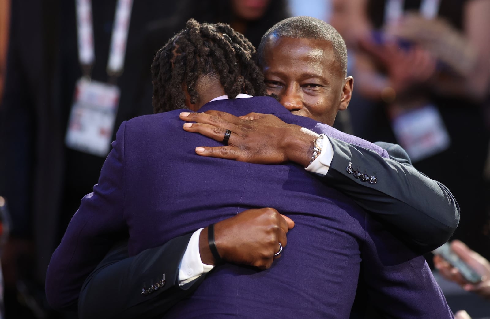 DaRon Holmes hugs Dayton's Anthony Grant after being selected with the No. 22 pick in the NBA Draft on Wednesday, June 26, 2024, at the Barclays Center in Brooklyn, N.Y. David Jablonski/Staff