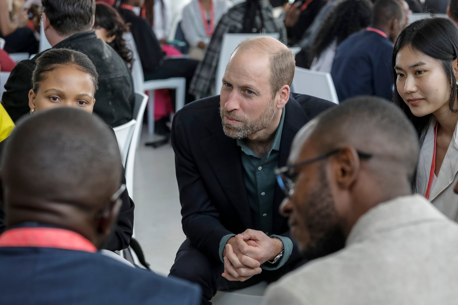 Britain's Prince William listens to a group of young people at the Earthshot Prize Climate Leaders Youth Programme at Rooftop on Bree in Cape Town, South Africa, Monday Nov. 4, 2024. (Gianluigi Guercia/Pool Photo via AP)