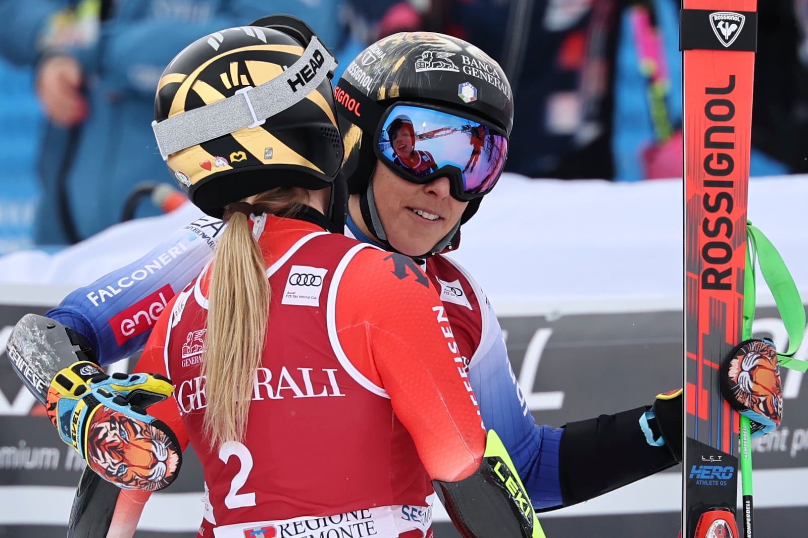 Switzerland's Lara Gut Behrami embraces Italy's Federica Brignone, right, after completing an alpine ski, women's World Cup giant slalom, in Sestriere, Italy, Saturday, Feb. 22, 2025. (AP Photo/Marco Trovati)