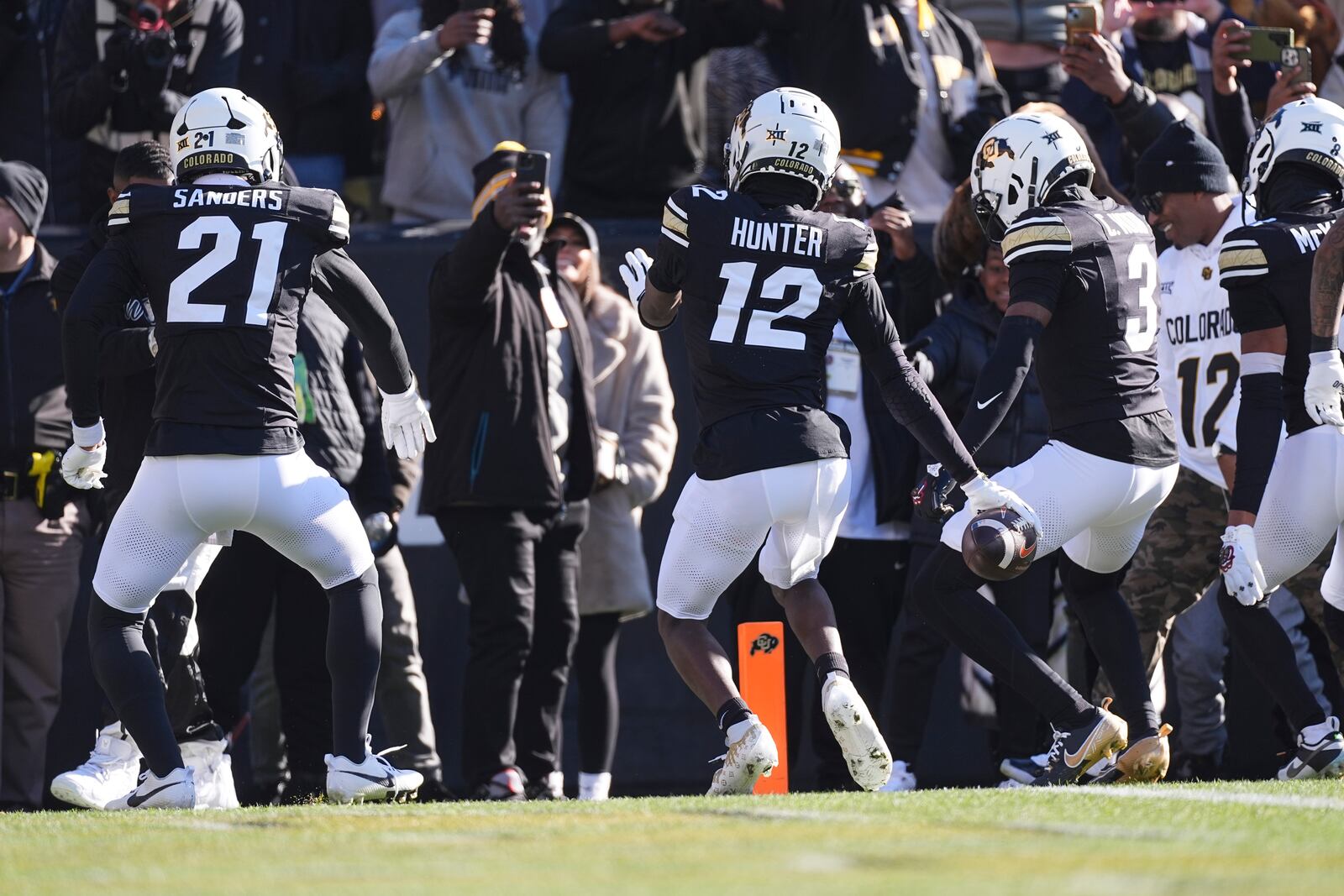 Colorado defensive back Travis Hunter, center, dances after intercepting a pass with safety Shilo Sanders, left, and cornerback Colton Hood in the first half of an NCAA college football game against Oklahoma State Friday, Nov. 29, 2024, in Boulder, Colo. (AP Photo/David Zalubowski)