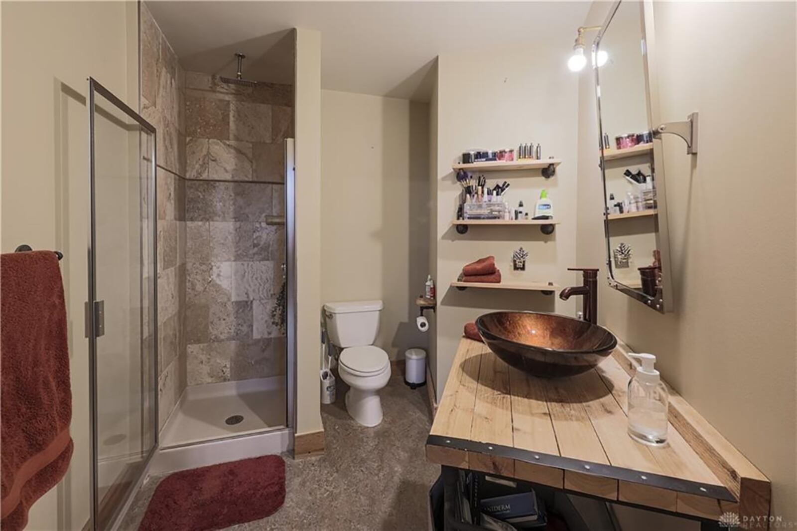 A second full bathroom is accessible from the great room and has also been updated. The bath features a corner step-in shower with ceramic-tile surround and a glass door, a copper bowl sink with pump-style faucet upon a wood-vanity counter. CONTRIBUTED PHOTO