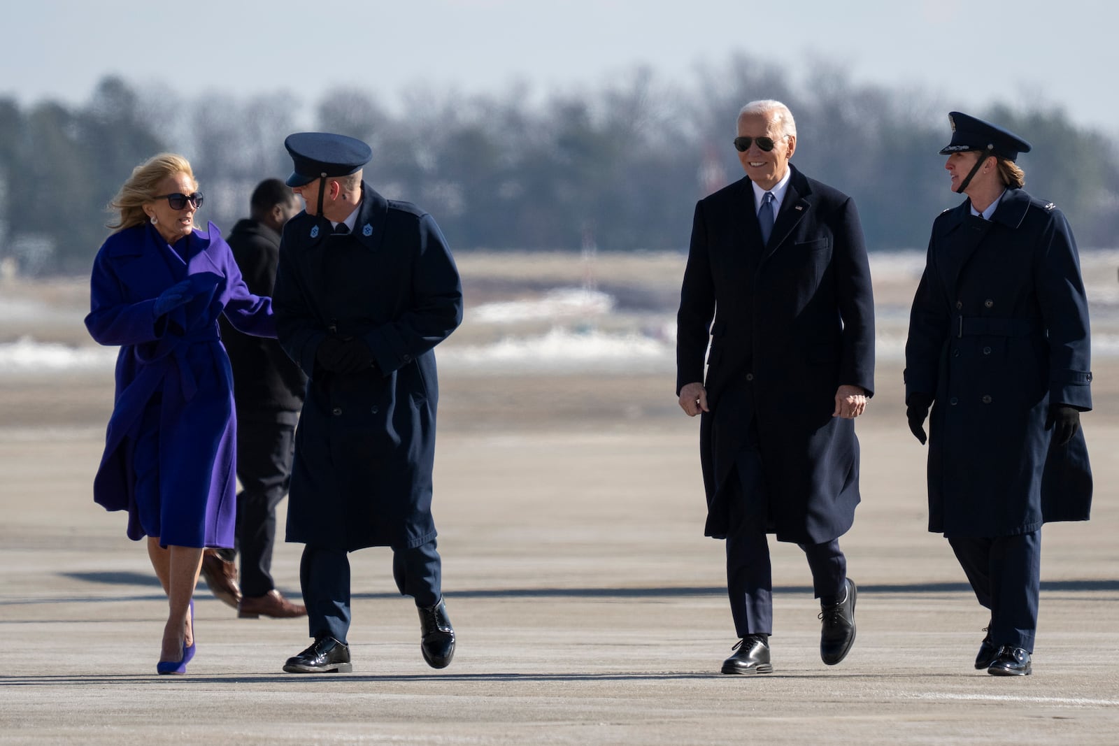 Jill Biden, Command Chief Master Sgt. Noah Bliss, 89th Airlift Wing, Former President Joe Biden and Col. Angela Ochoa, Commander, 89th Airlift Wing, left, walk at Joint Base Andrews, Md., Monday, Jan. 20, 2025. (AP Photo/Jess Rapfogel)