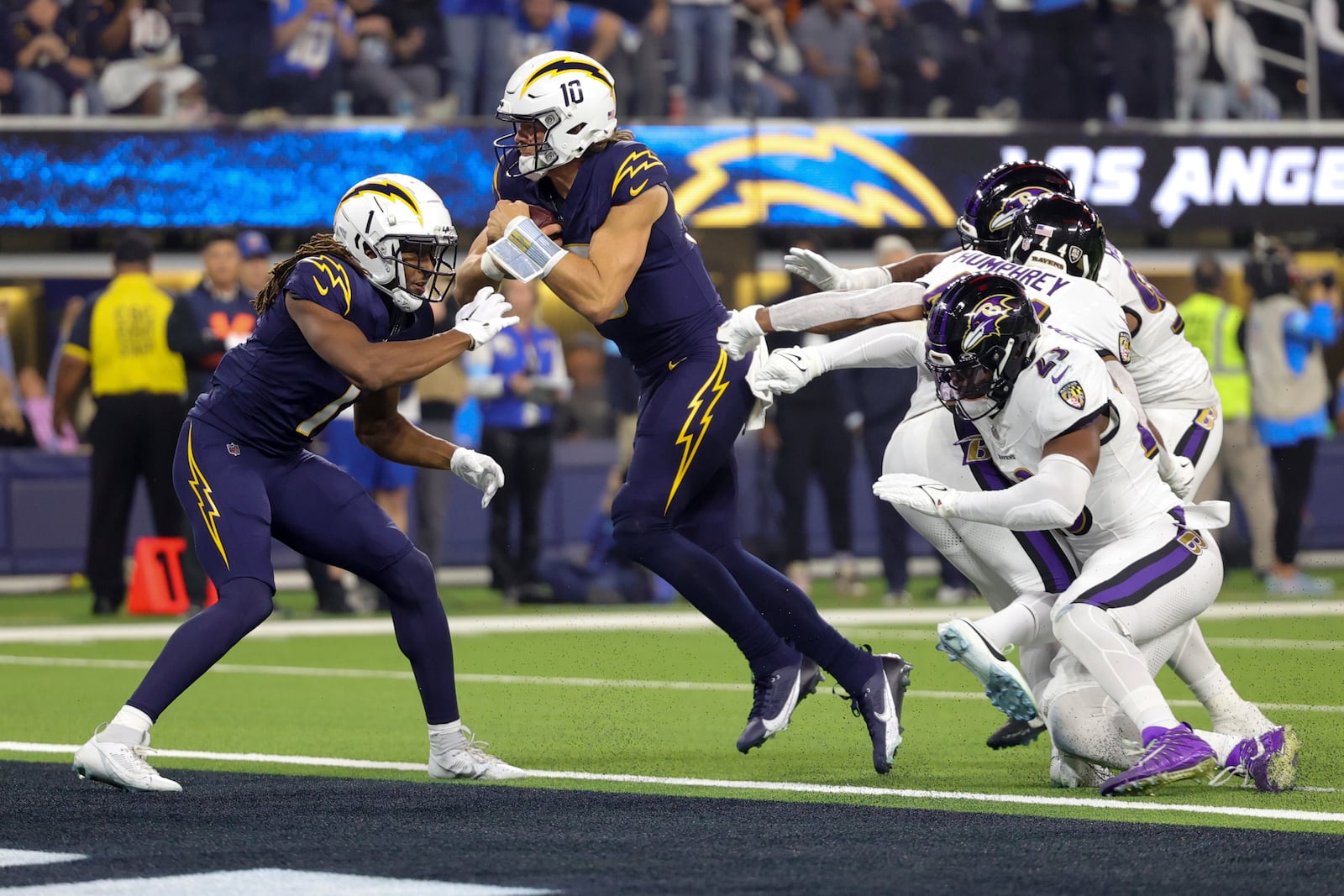 Los Angeles Chargers quarterback Justin Herbert (10) scores a rushing touchdown during the first half of an NFL football game against the Baltimore Ravens, Monday, Nov. 25, 2024, in Inglewood, Calif. (AP Photo/Ryan Sun)