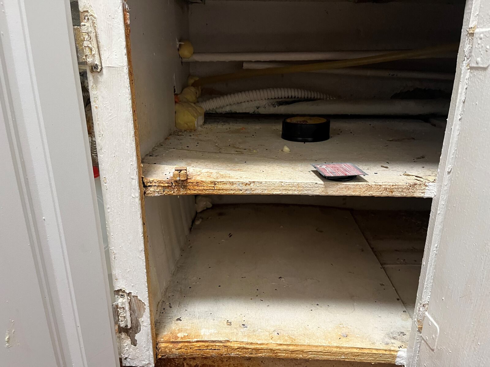 One of the kitchen cabinets in an apartment at the Rustic Arms. The tenant says she can't use her bottom cabinets because of mice. CORNELIUS FROLIK / STAFF