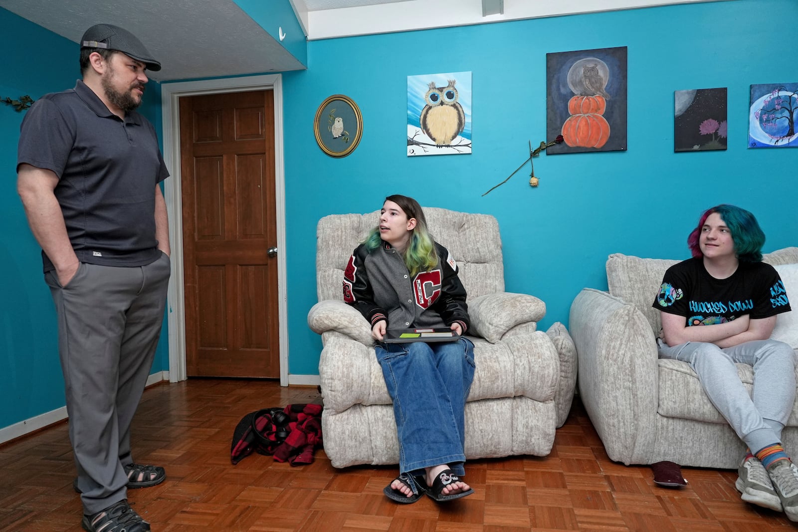 Tim Reiland, 42, left, the parent of daughter Zoe Reiland, 17, center, and Anakin Reiland, 15, photographed in Clinton, Miss., Monday, March 10, 2025, said he had no idea their previous schools, in Oklahoma, were using surveillance technology to monitor the students. (AP Photo/Rogelio V. Solis)