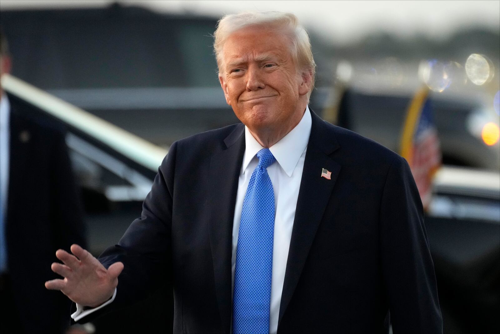 President Donald Trump waves as he arrives on Air Force One at Palm Beach International Airport in West Palm Beach, Fla., Friday, Feb. 7, 2025. (AP Photo/Ben Curtis)