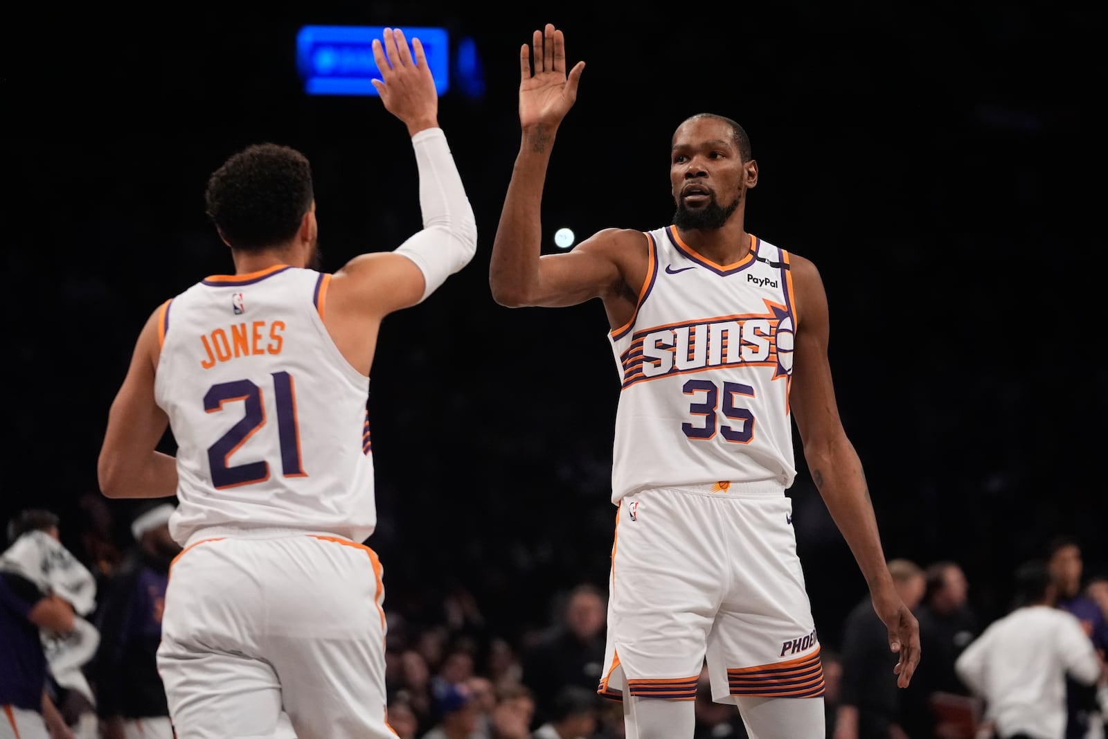 Phoenix Suns' Kevin Durant (35) celebrates with Tyus Jones (21) after Jones scored during the first half of an NBA basketball game against the Brooklyn Nets Wednesday, Jan. 22, 2025, in New York. (AP Photo/Frank Franklin II)