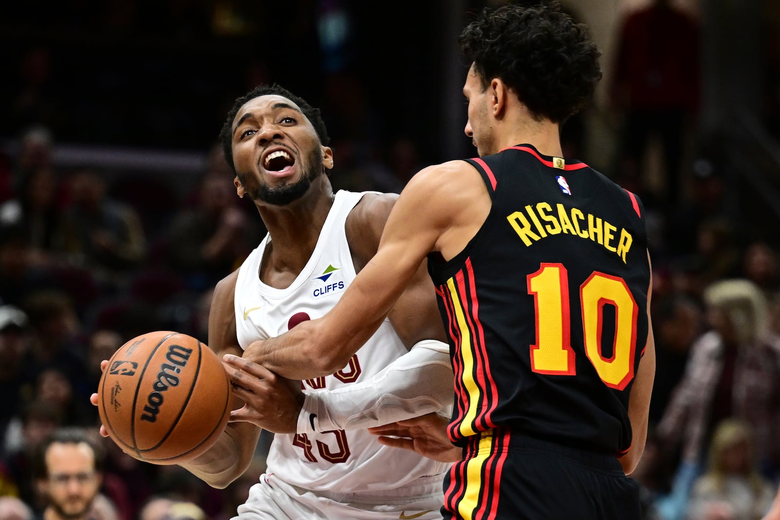 Cleveland Cavaliers guard Donovan Mitchell drives on Atlanta Hawks forward Zaccharie Risacher in the first half of an NBA basketball game, Wednesday, Nov. 23, 2024, in Cleveland. (AP Photo/David Dermer)