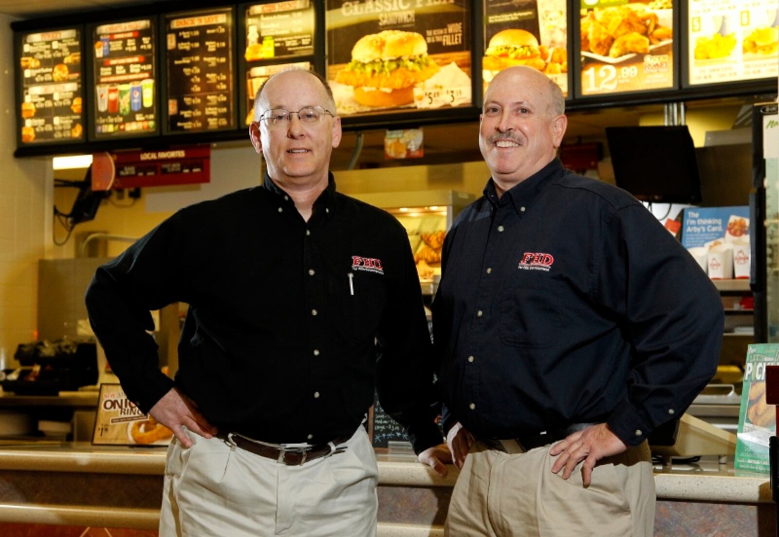 Ken Riddle (left) and Chuck Doran are the co-founders of Far Hills Development LLC and operate over a dozen Lee’s Famous Recipe restaurants. LISA POWELL/STAFF