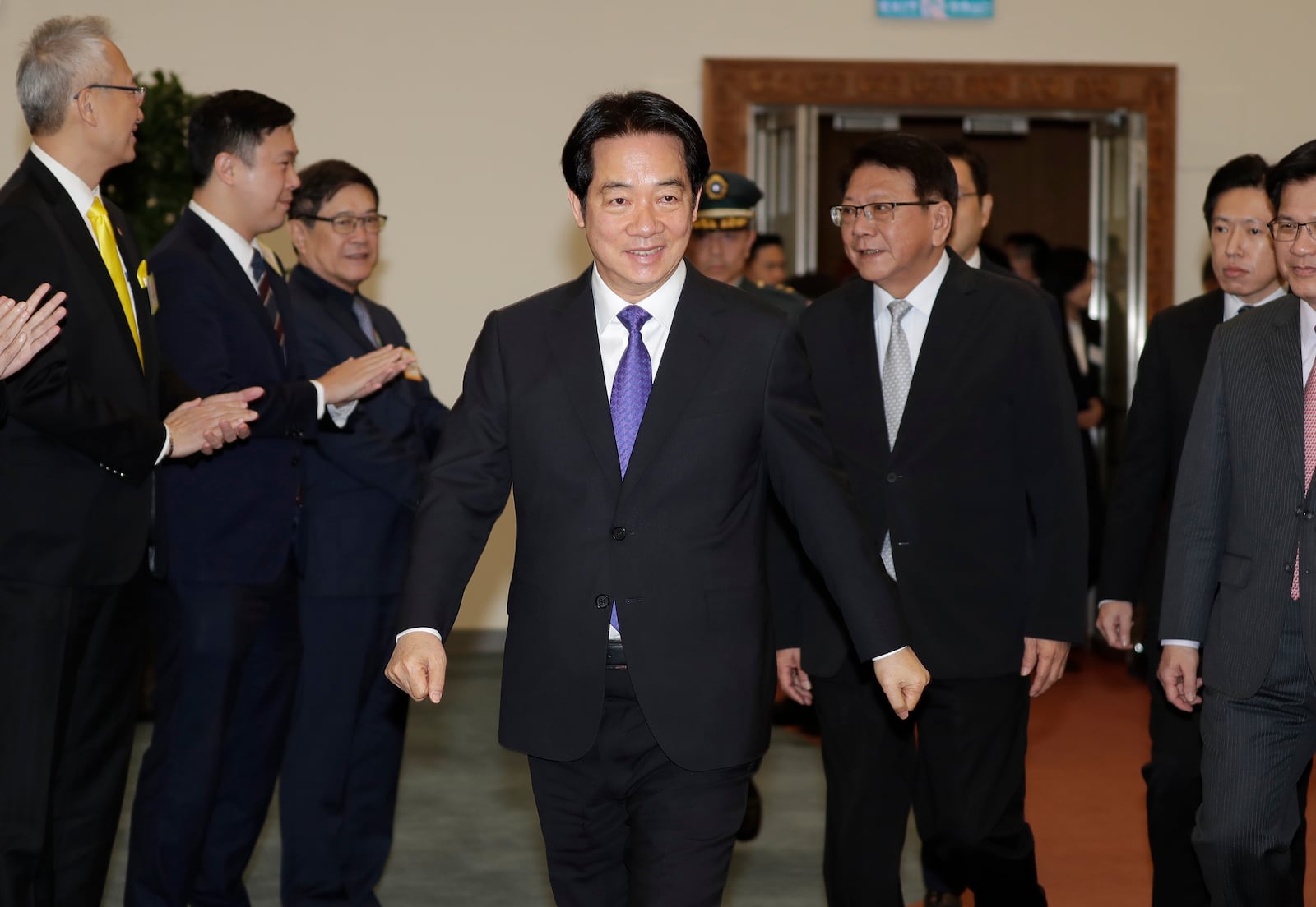 Taiwanese President Lai Ching-te smiles to the media as he departs for South Pacific at Taoyuan International Airport in Taoyuan, Taiwan, Saturday, Nov. 30, 2024. Lai leave Taiwan on Saturday on a weeklong trip to visit the Marshall Islands, Tuvalu and Palau 'X three diplomatic allies of the self-governed island. (AP Photo/Chiang Ying-ying)