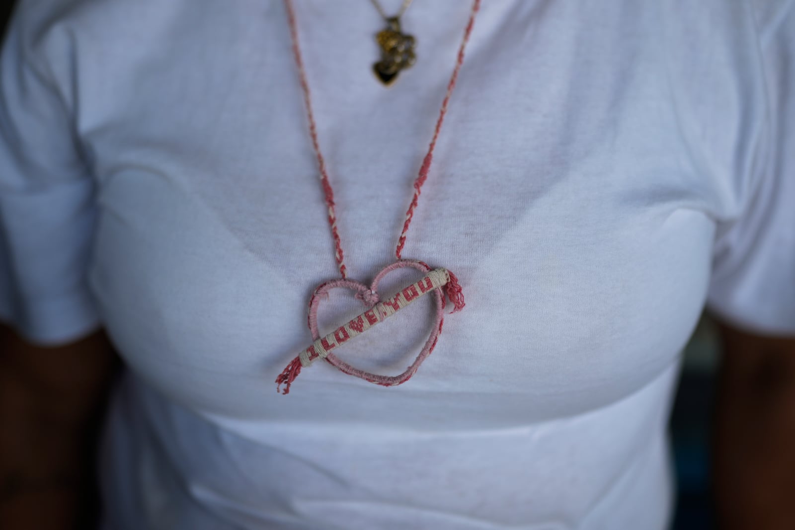 The wife of a prisoner detained in a post-election crackdown wears a necklace that he made for her in prison, after her visit to Tocuyito Prison, in Tocuyito, Venezuela, Monday, Jan. 20, 2025. (AP Photo/Ariana Cubillos)