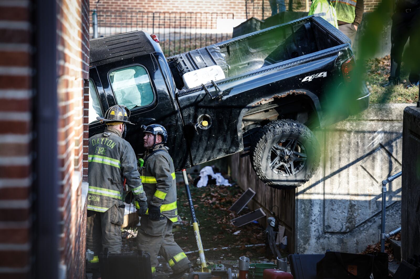 A pickup truck crashed into an apartment building at Wayne and Wilmington avenues Thursday, Oct. 27, 2022, in Dayton, injuring two people sitting on a couch in an apartment and two people in the truck. JIM NOELKER/STAFF