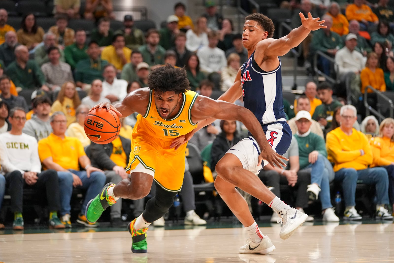 Baylor forward Norchad Omier (15) drives to the basket against Arizona forward Carter Bryant during the first half of an NCAA college basketball game Monday, Feb. 17, 2025, in Waco, Texas. (AP Photo/Julio Cortez)