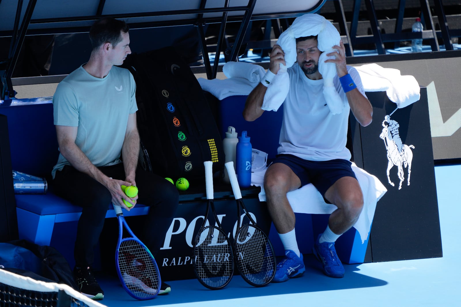 Serbia's Novak Djokovic talks with his coach Andy Murray, left, during a practice session ahead of the Australian Open tennis championship in Melbourne, Australia, Saturday, Jan. 11, 2025. (AP Photo/Ng Han Guan)