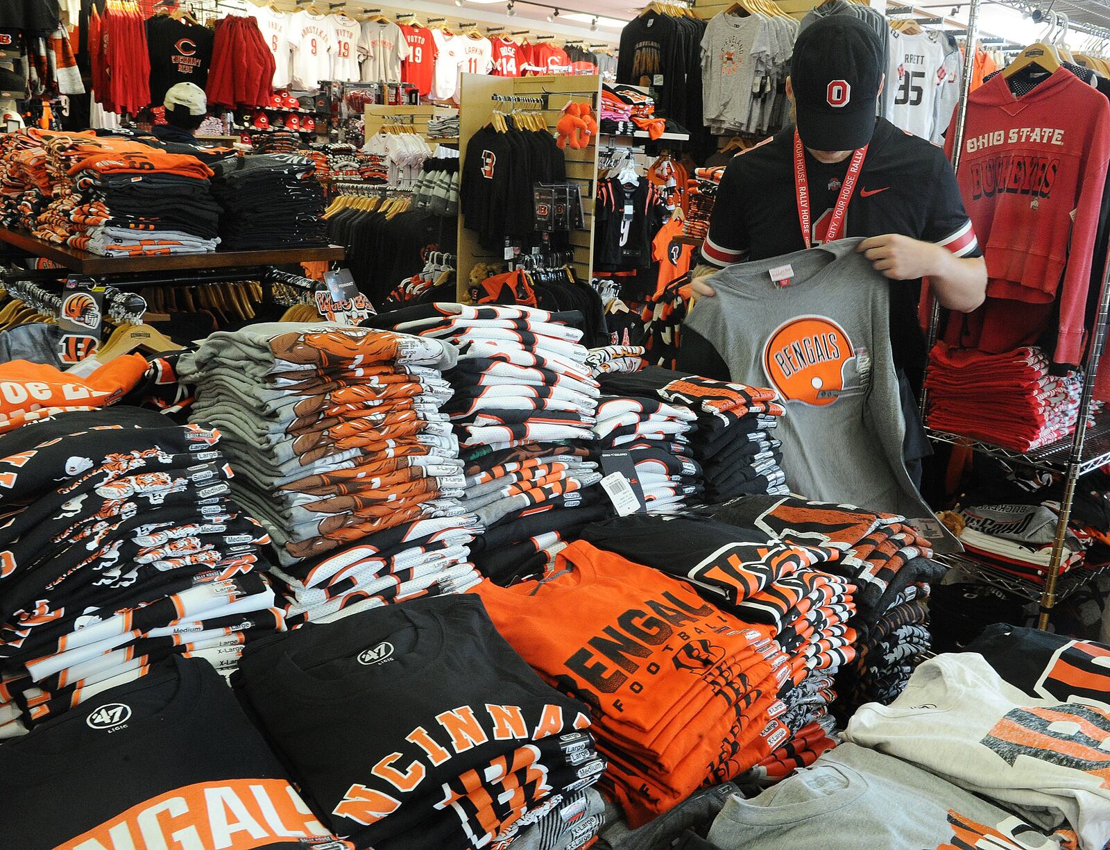 Rally House employee Cole McCandless folds Cincinnati Bengals T-shirts Thursday Sept. 8, 2022. MARSHALL GORBY\STAFF