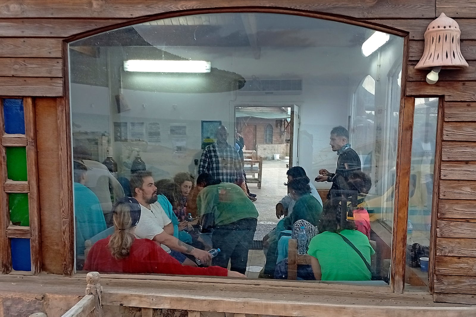 Survivors rest at a coffee shop in Marsa Alam, Egypt, Monday, Nov. 25, 2024 after a tourist yacht sank in the Red Sea following warnings about rough seas. (AP Photo)