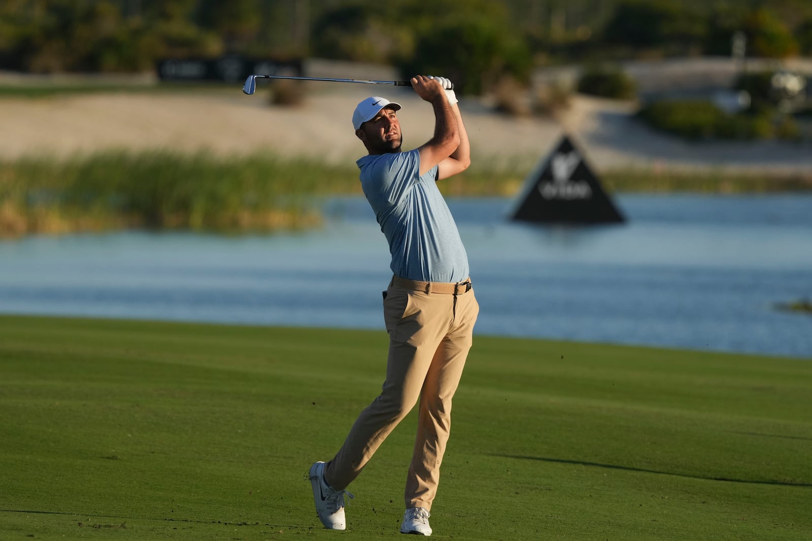 Scottie Scheffler, of the United States, watches his shot from the 18th fairway during the final round of the Hero World Challenge PGA Tour at the Albany Golf Club in New Providence, Bahamas, Sunday, Dec. 8, 2024. (AP Photo/Fernando Llano)