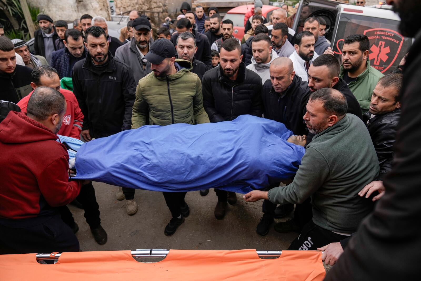 Mourners carry the body of Ahmad Nimer Al-Shaib after he was killed during an Israeli military operation in Jenin, in the West Bank village of Bruqin, Wednesday, Jan. 22, 2025. (AP Photo/Majdi Mohammed)