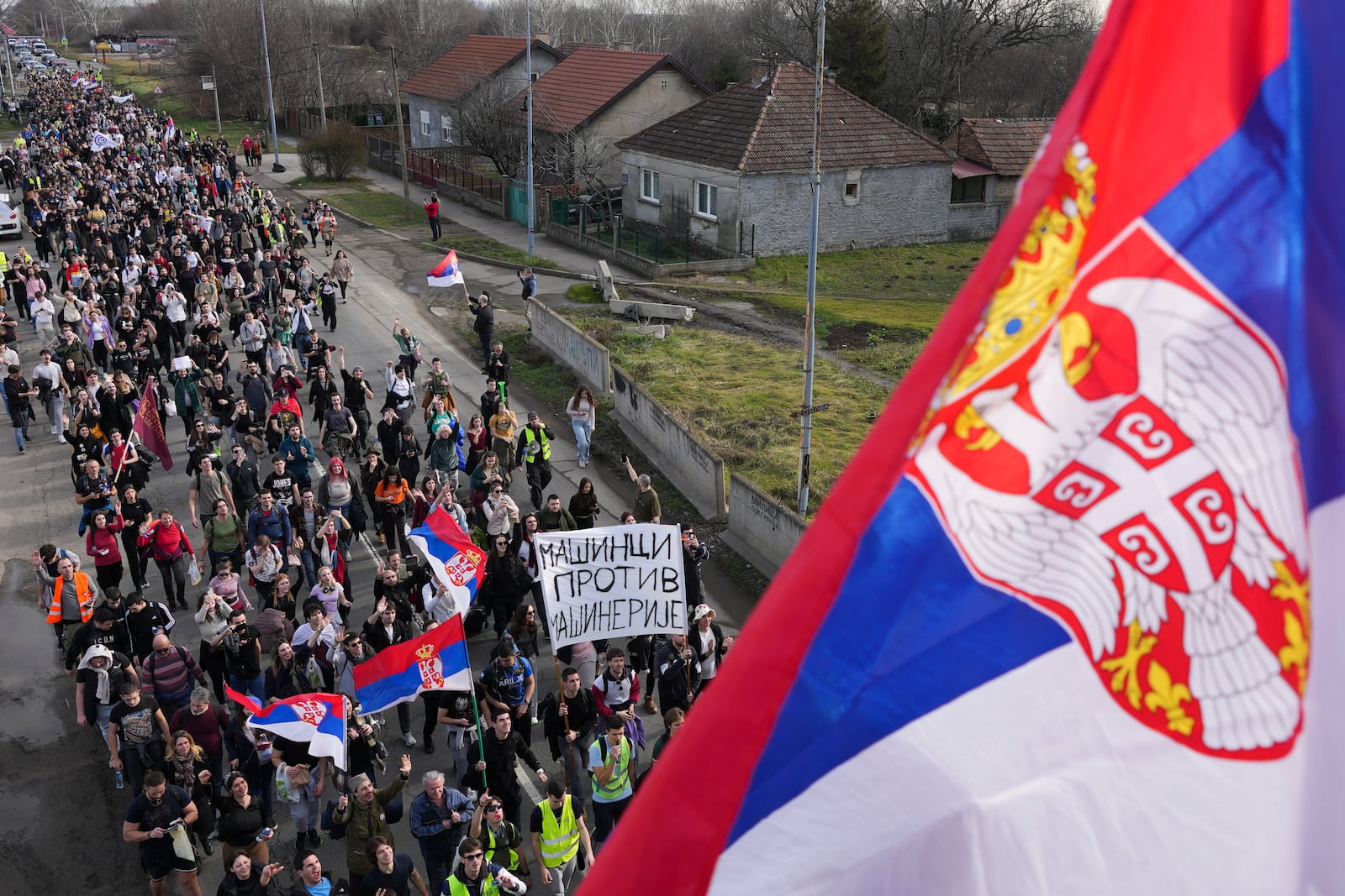 Students walk on the road towards the northern city of Novi Sad, where they will participate in a 24 hour block of three bridges to protest the deaths of 15 people killed in the November collapse of a train station canopy, near the Belgrade suburb of Batajnica, Serbia, Thursday, Jan. 30, 2025. (AP Photo/Darko Vojinovic)