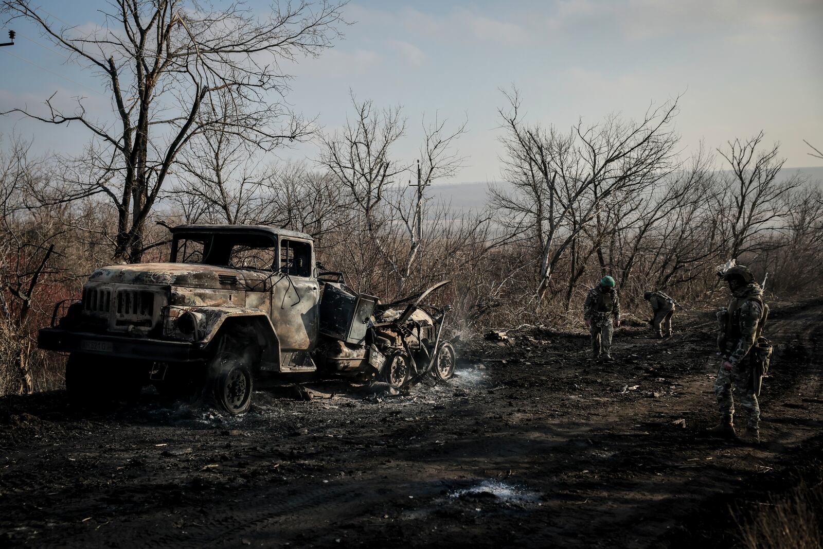 Ukrainian servicemen collect damaged ammunition on the road at the front line near Chasiv Yar town, in Donetsk region, Ukraine, Ukraine, Friday, Jan. 10, 2025. (Oleg Petrasiuk/Ukraine's 24th Mechanised Brigade via AP)