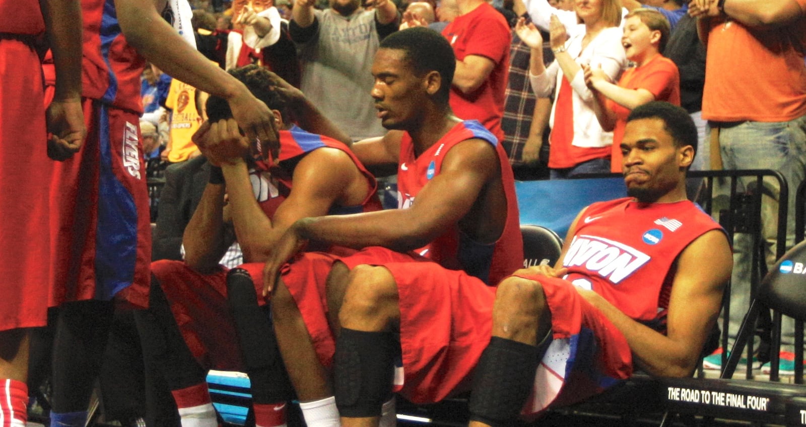 Dayton's Devin Oliver, center, hides his tears as Dyshawn Pierre consoles him and Vee Sanford, far right, looks on as the final seconds tick away in a loss to Florida in the South Regional final on Saturday, March 29, 2014, at FedExForum in Memphis, Tenn. David Jablonski/Staff