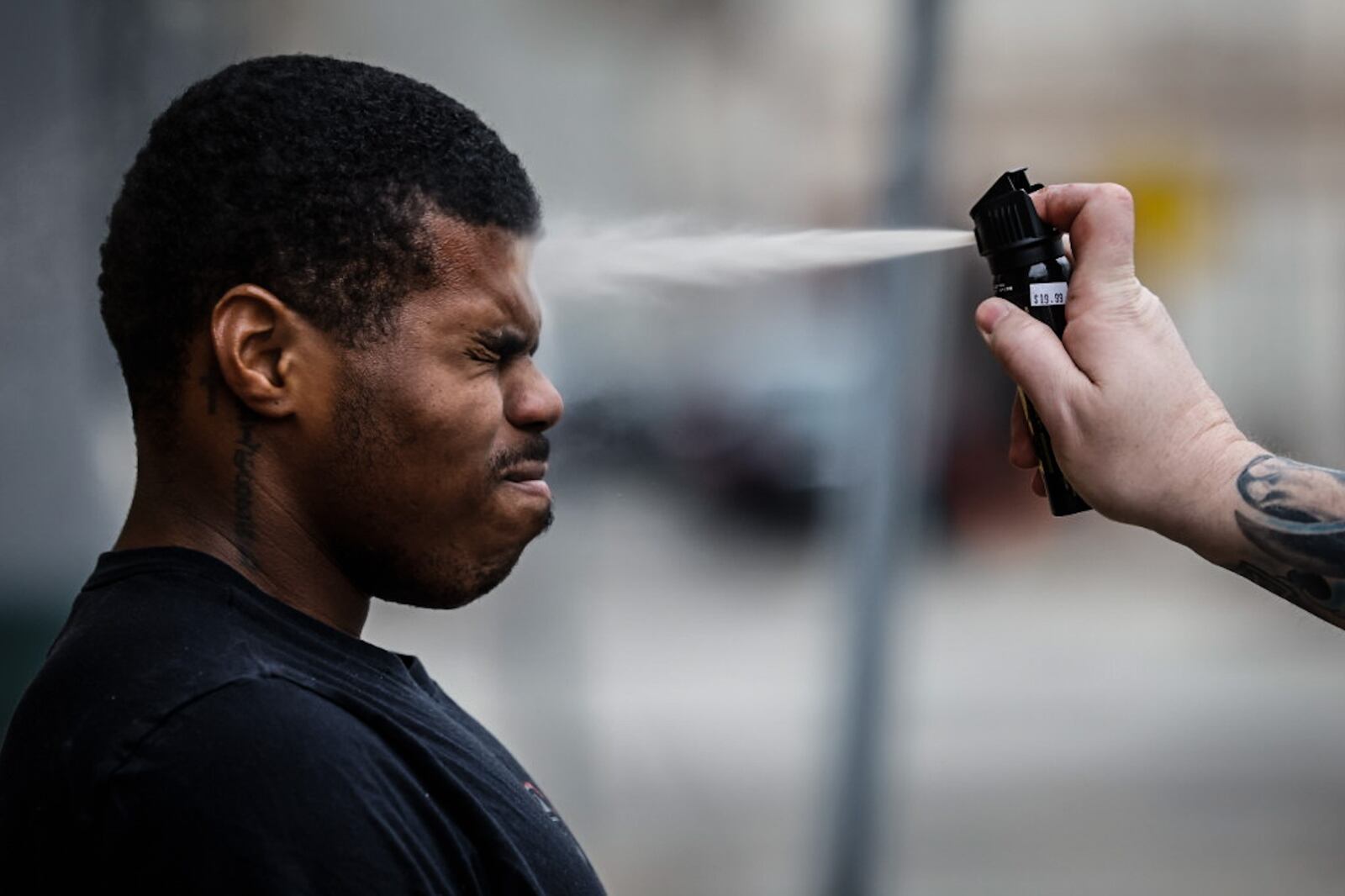 Sinclair Collage police academy cadet, Raquan O'Berry is sprayed with pepper spray during class. About two dozen cadets participated in the exercise to find out what it fells like to use the chemical. JIM NOELKER/STAFF