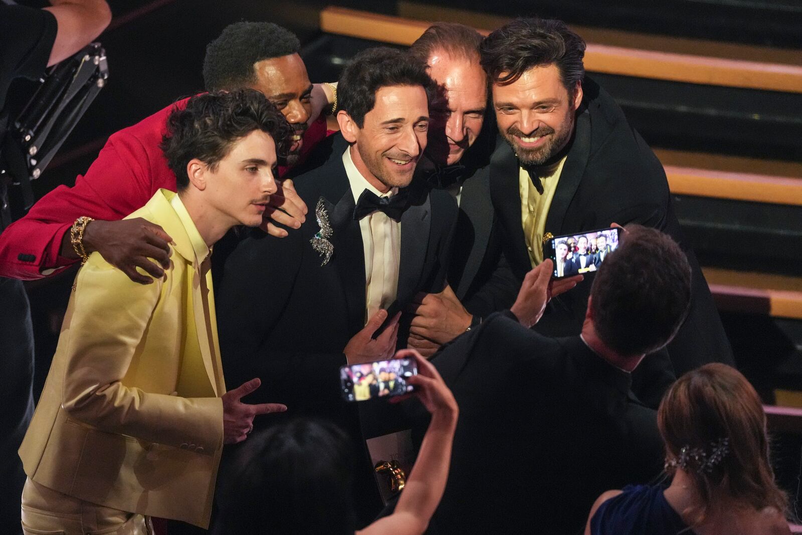 Timothee Chalamet, from left, Colman Domingo, Adrien Brody, Ralph Fiennes, and Sebastian Stan pose in the audience during the Oscars on Sunday, March 2, 2025, at the Dolby Theatre in Los Angeles. (AP Photo/Chris Pizzello)