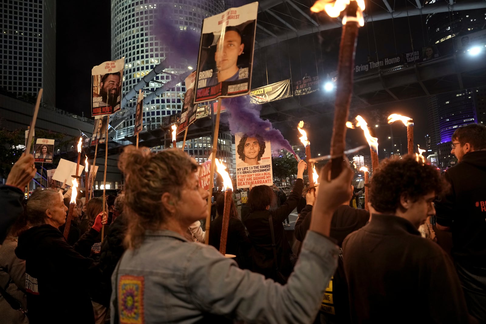 Relatives and friends of people killed and abducted by Hamas and taken into Gaza, react to the ceasefire announcement as they take part in a demonstration in Tel Aviv, Israel, Wednesday, Jan. 15, 2025. (AP Photo/Oded Balilty)