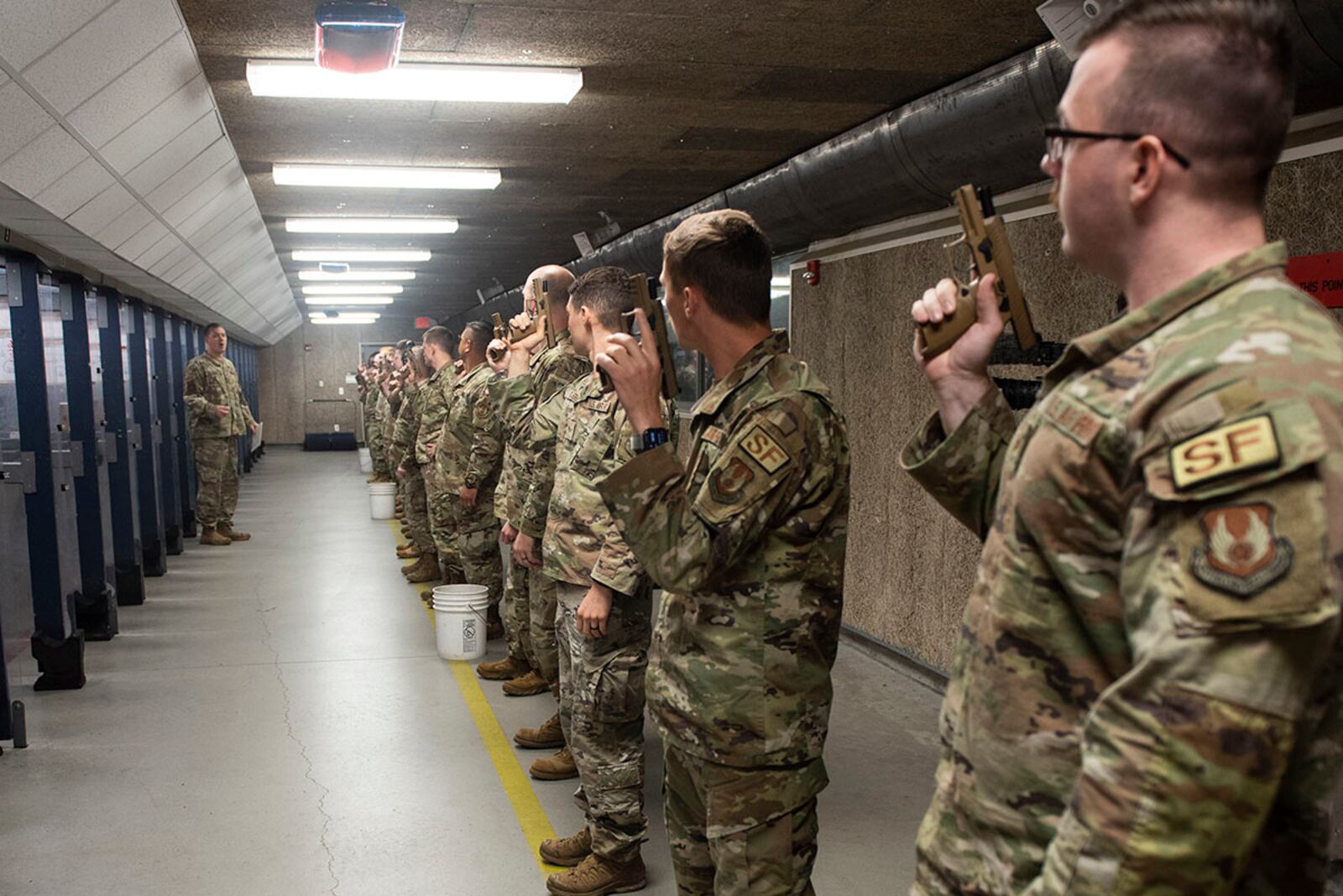 Participants listen to final instructions before beginning the firing portion of the Excellence in Competition shooting event held as part of Police Week at Wright-Patterson Air Force Base on May 17. During the competition participants competed for the best score with both pistols and rifles. U.S. AIR FORCE PHOTO/WESLEY FARNSWORTH