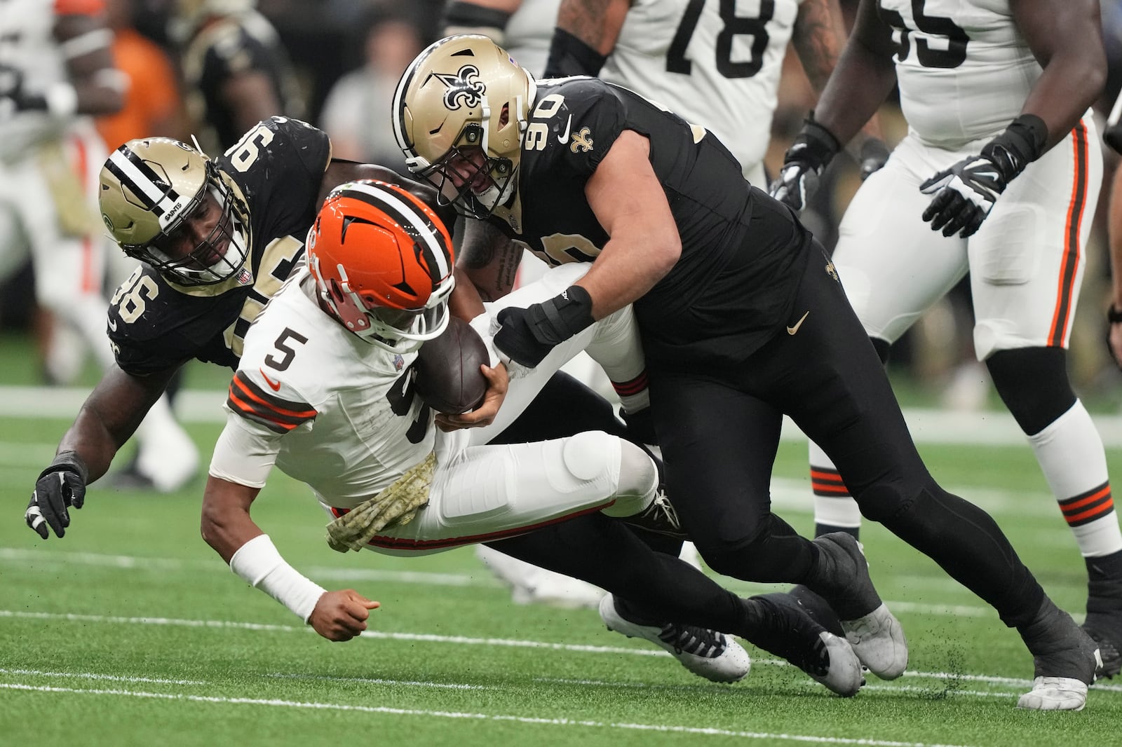 Cleveland Browns quarterback Jameis Winston (5) is sacked by New Orleans Saints defensive end Carl Granderson, left, and defensive tackle Bryan Bresee (90) in the second half of an NFL football game in New Orleans, Sunday, Nov. 17, 2024. (AP Photo/Gerald Herbert)