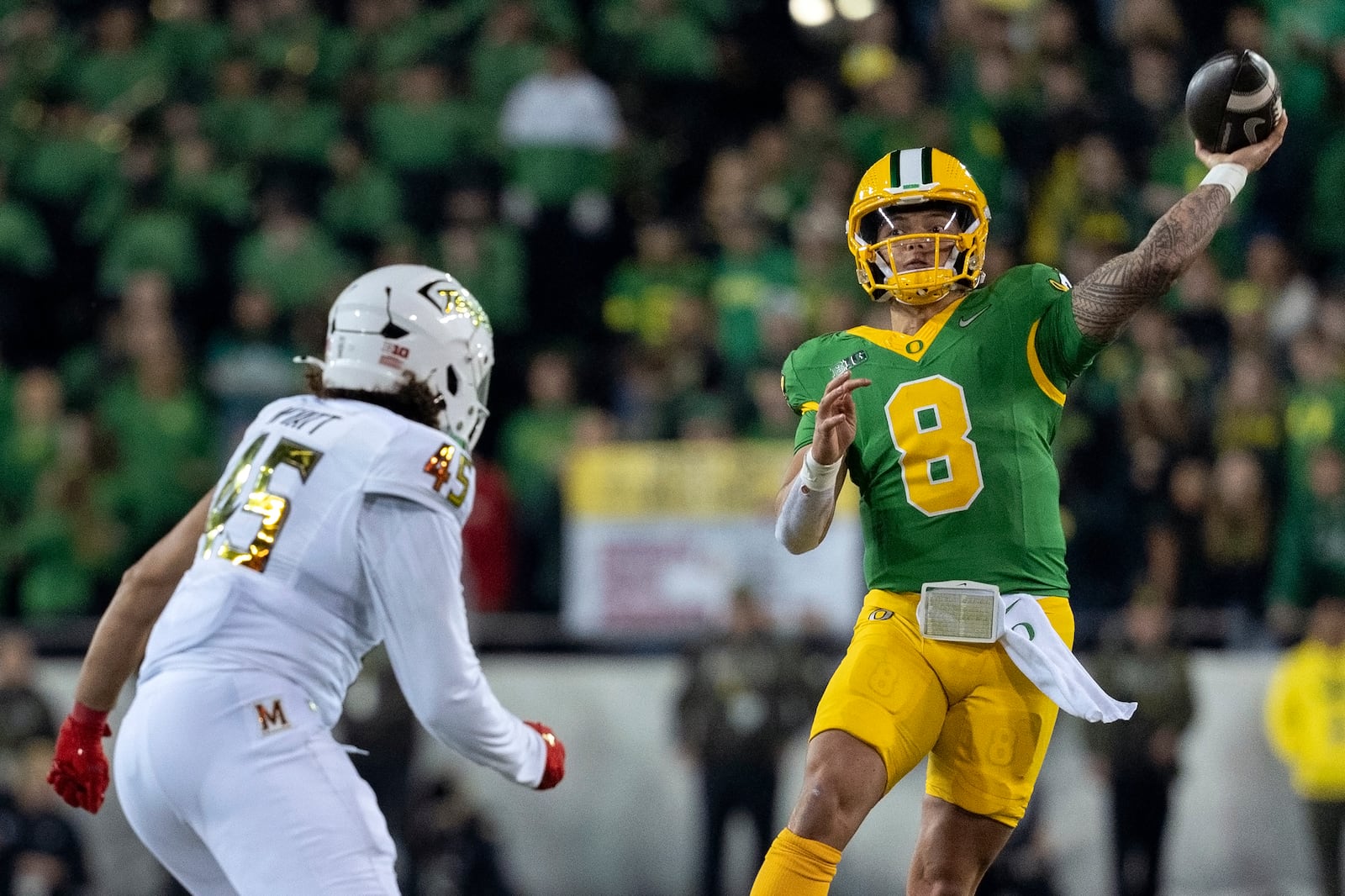 Oregon quarterback Dillon Gabriel (8) throws the ball as Maryland linebacker Kellan Wyatt (45) defends during the second half of an NCAA college football game on Saturday, Nov. 9, 2024, in Eugene, Ore. Oregon won 39-18. (AP Photo/Jenny Kane)