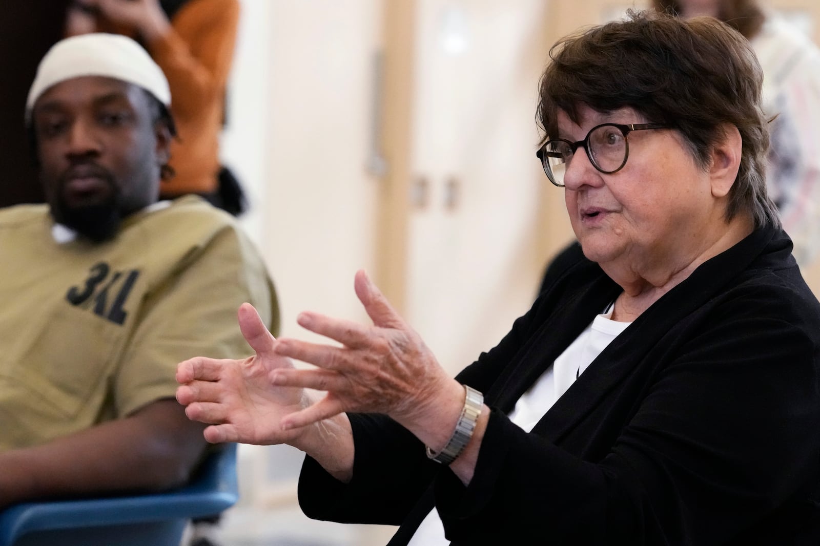 Sister Helen Prejean, right, talks during a book club as detainee listens at Department Of Corrections Division 11 in Chicago, Monday, April 22, 2024. DePaul students and detainees are currently reading Dead Man Walking and the author, anti death penalty advocate, Sister Helen Prejean attended to lead a discussion. (AP Photo/Nam Y. Huh)